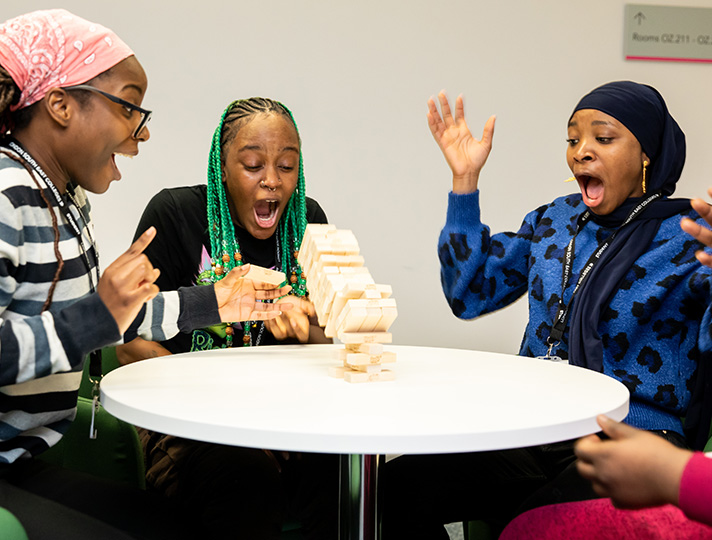 Students playing jenga in the common room