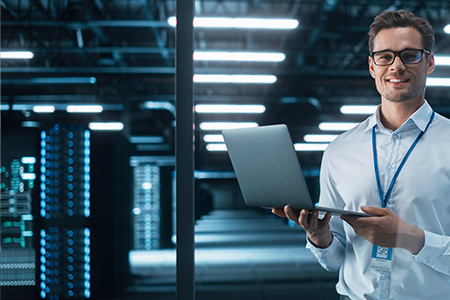 man in a server room at night