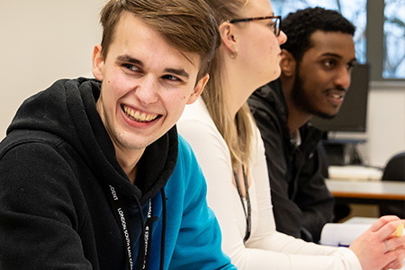 3 students working in a classroom